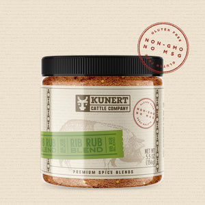 A 5 oz jar of Kunert Cattle Company: Rib Rub Blend seasoning. The label features the company logo, on a cream background superimposed with a cow, with a light green insert containing the subheading “Rib Rub Blend” in block letters. The label also contains the claims “gluten-free, non-GMO, no MSG.”