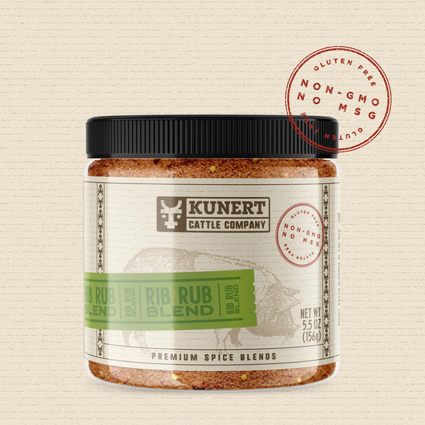 A 5 oz jar of Kunert Cattle Company: Rib Rub Blend seasoning. The label features the company logo, on a cream background superimposed with a cow, with a light green insert containing the subheading “Rib Rub Blend” in block letters. The label also contains the claims “gluten-free, non-GMO, no MSG.”