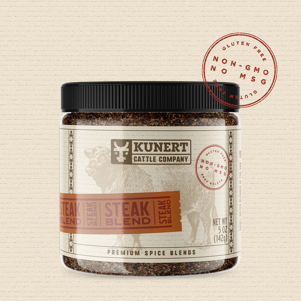 A 5 oz jar of Kunert Cattle Company: Steak Blend seasoning. The label features the company logo, on a cream background superimposed with a cow, with an orange-brown insert containing the subheading “Steak Blend” in block letters. The label also contains the claims “gluten-free, non-GMO, no MSG.”