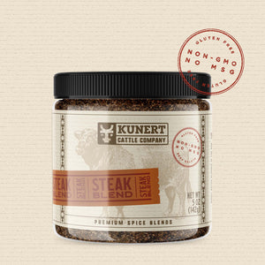 A 5 oz jar of Kunert Cattle Company: Steak Blend seasoning. The label features the company logo, on a cream background superimposed with a cow, with an orange-brown insert containing the subheading “Steak Blend” in block letters. The label also contains the claims “gluten-free, non-GMO, no MSG.”